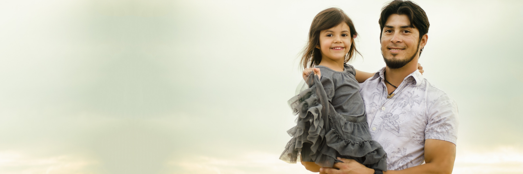 young man holding daughter l family dentistry prosper tx
