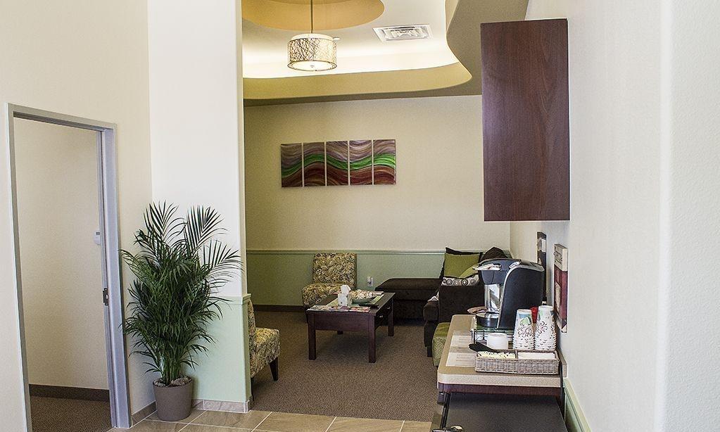 Complementary beverage station in patient waiting area at 75078 dentist office
